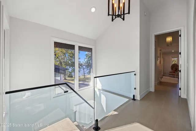 a view of hallway with stairs and wooden floor