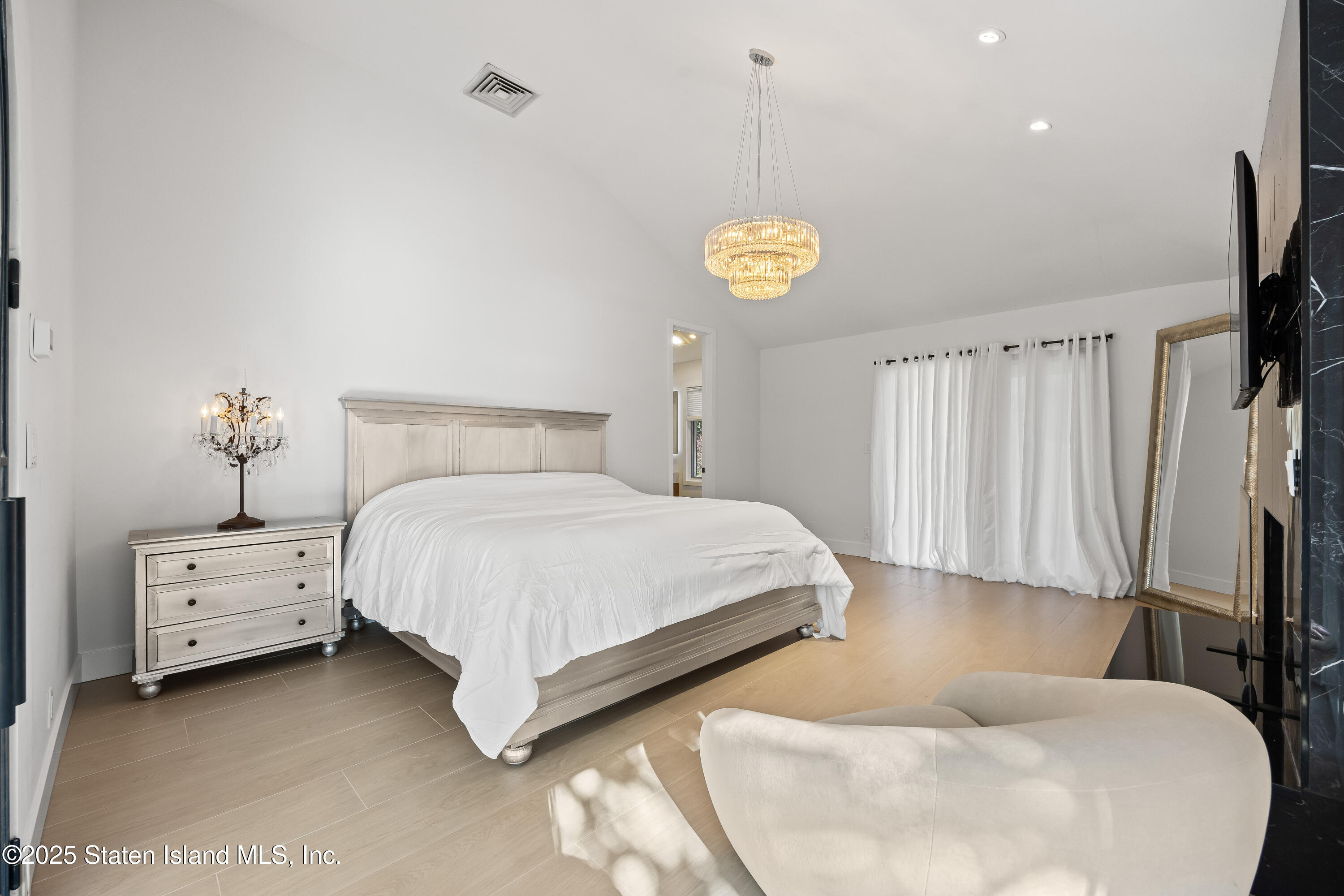 2 Wards Point Avenue Staten Island, NY 10307 - Photo 27 of 38 a bed room with a bed and a chandelier