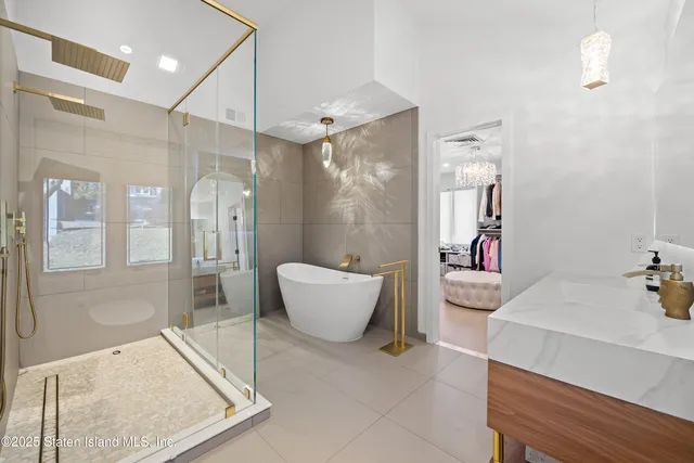 a bathroom with a tub sink and mirror