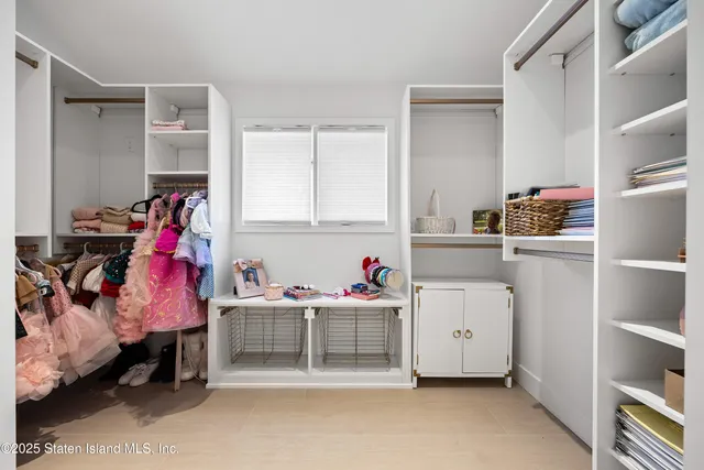 a living room with baby furniture and closet