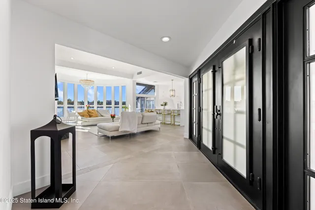 a living room with furniture and a floor to ceiling window