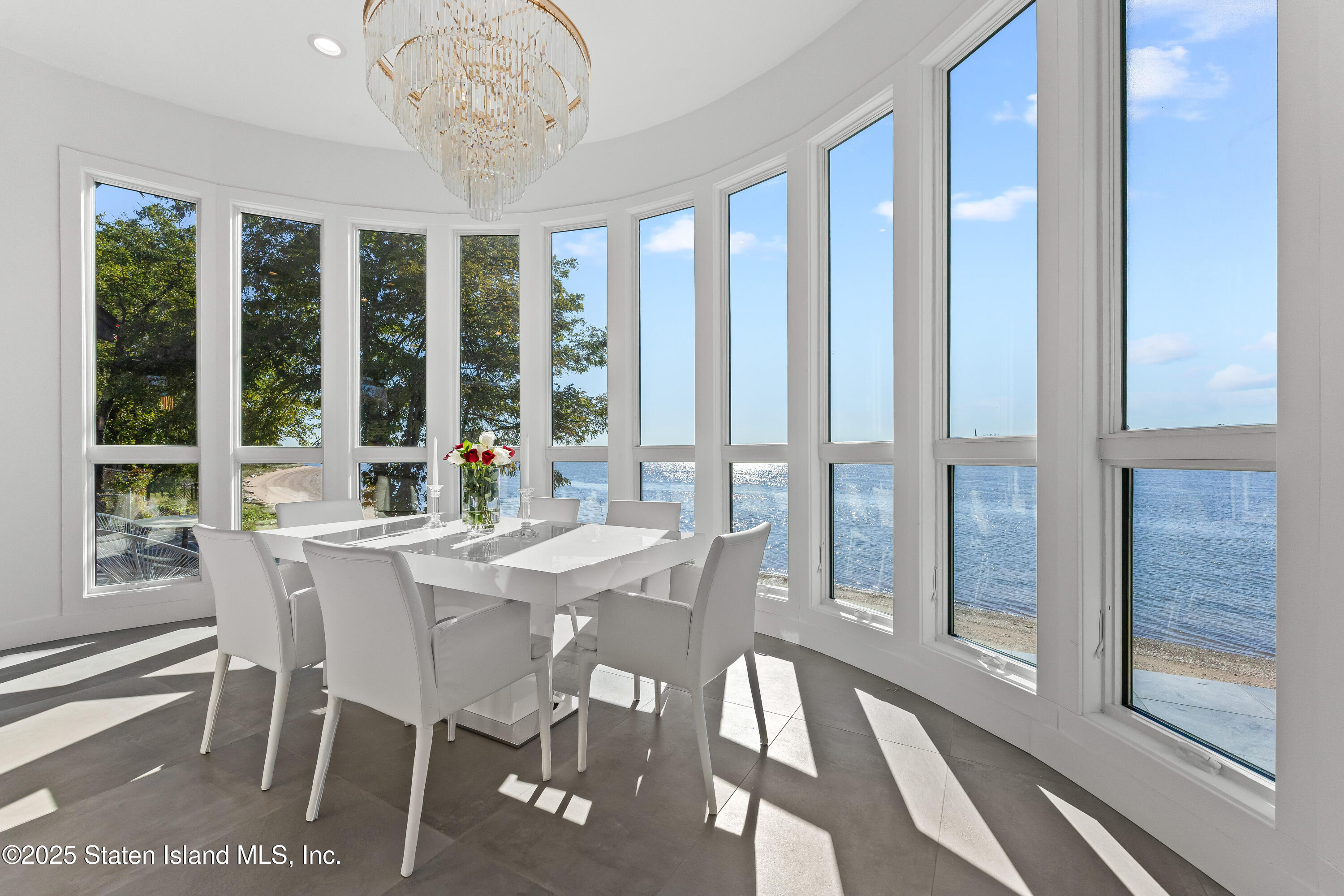 2 Wards Point Avenue Staten Island, NY 10307 - Photo 9 of 38 a view of a dining room with furniture large windows and wooden floor