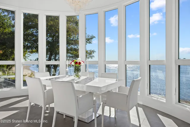 a dining room with furniture a chandelier and wooden floor