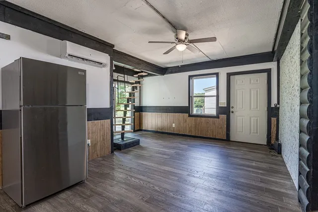 a view of a livingroom with an empty space and a fireplace