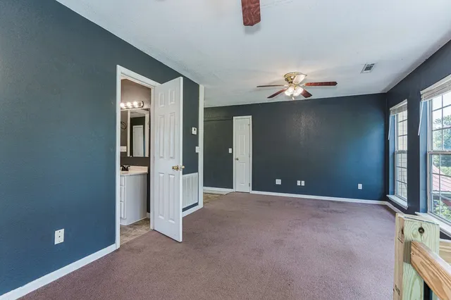 a view of an empty room with windows chandelier