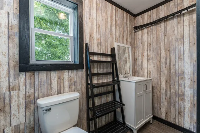 a bathroom with a toilet a sink and tub