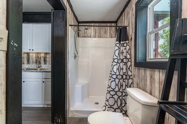 a bathroom with a toilet and a shower