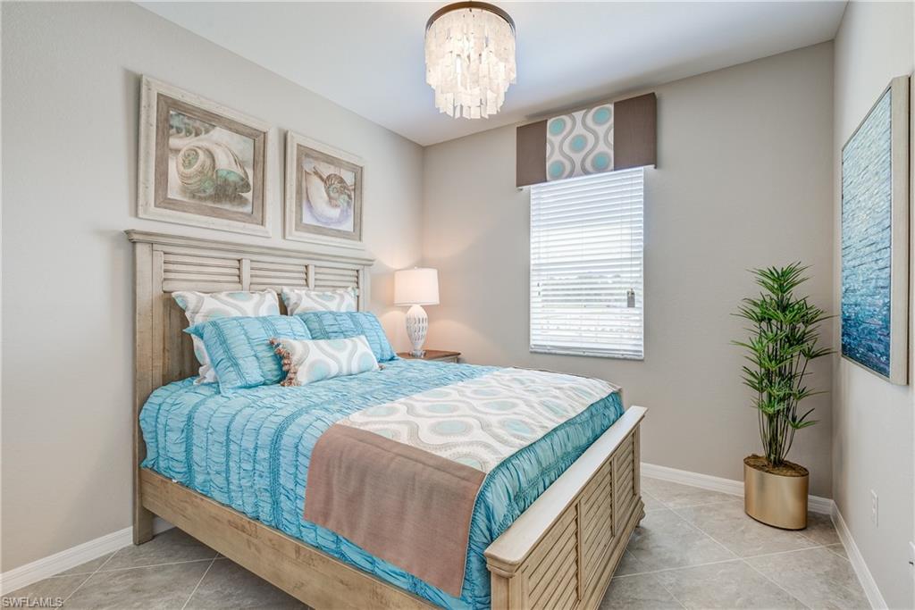 2595 Scarlet Way Naples, FL 34120 - Photo 18 of 27 a bedroom with a bed and a potted plant