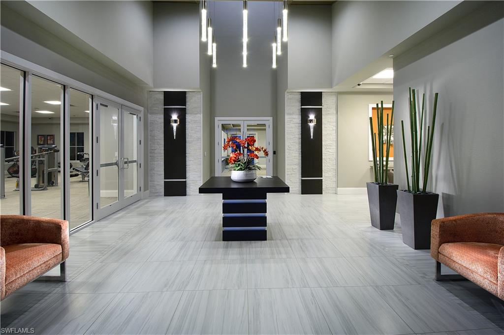 2595 Scarlet Way Naples, FL 34120 - Photo 23 of 27 a view of a hallway with wooden floor and furniture