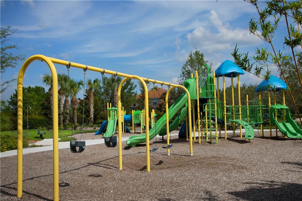 2595 Scarlet Way Naples, FL 34120 - Photo 27 of 27 a view of a swimming pool with a table and chairs