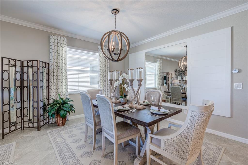 2595 Scarlet Way Naples, FL 34120 - Photo 5 of 27 a view of a dining room with furniture window and wooden floor