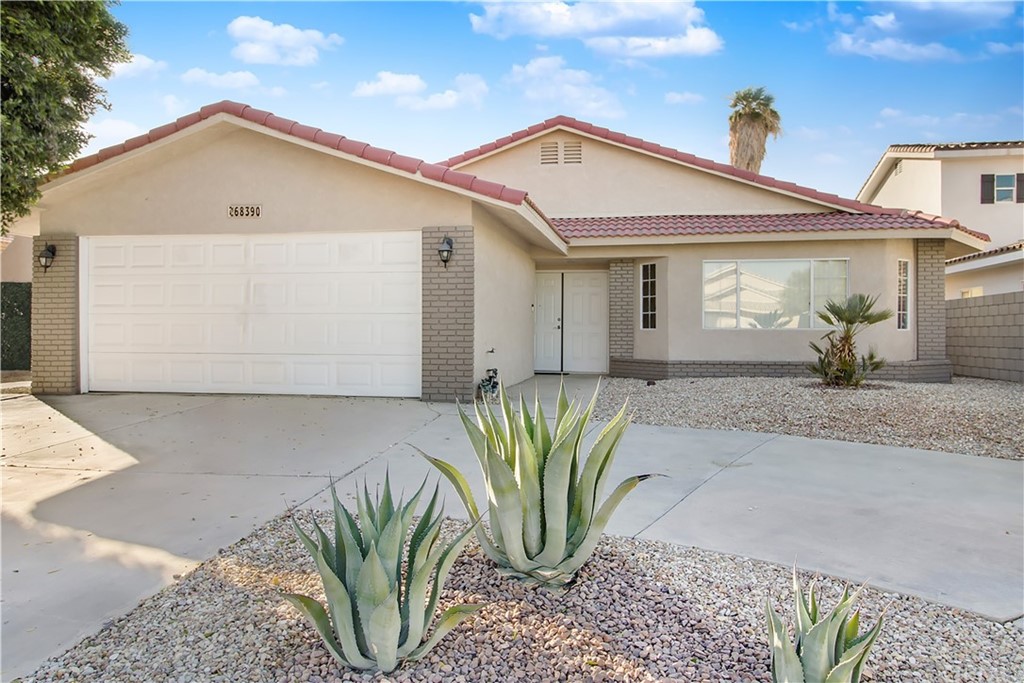 68390 Risueno Road Cathedral City, CA 92234 - Photo 1 of 1 a front view of a house with a garden