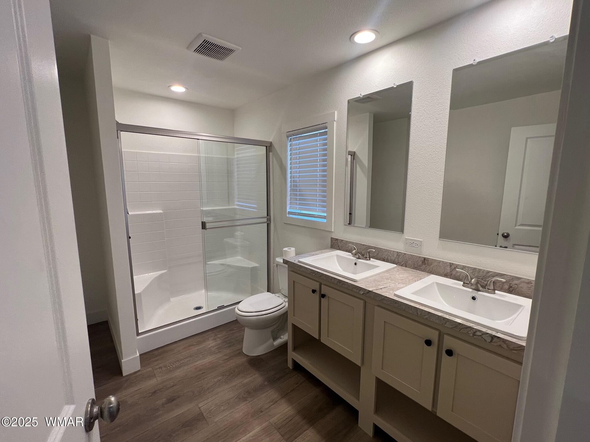4129 Apache Road Snowflake, AZ 85937 - Photo 22 of 48 a bathroom with a granite countertop sink toilet a mirror and shower