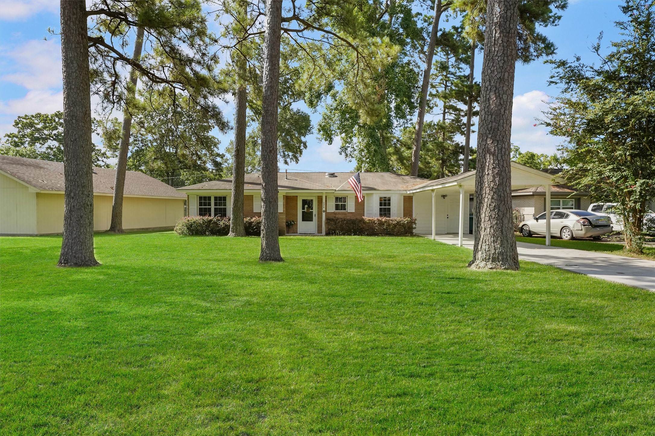 a front view of house with yard and green space