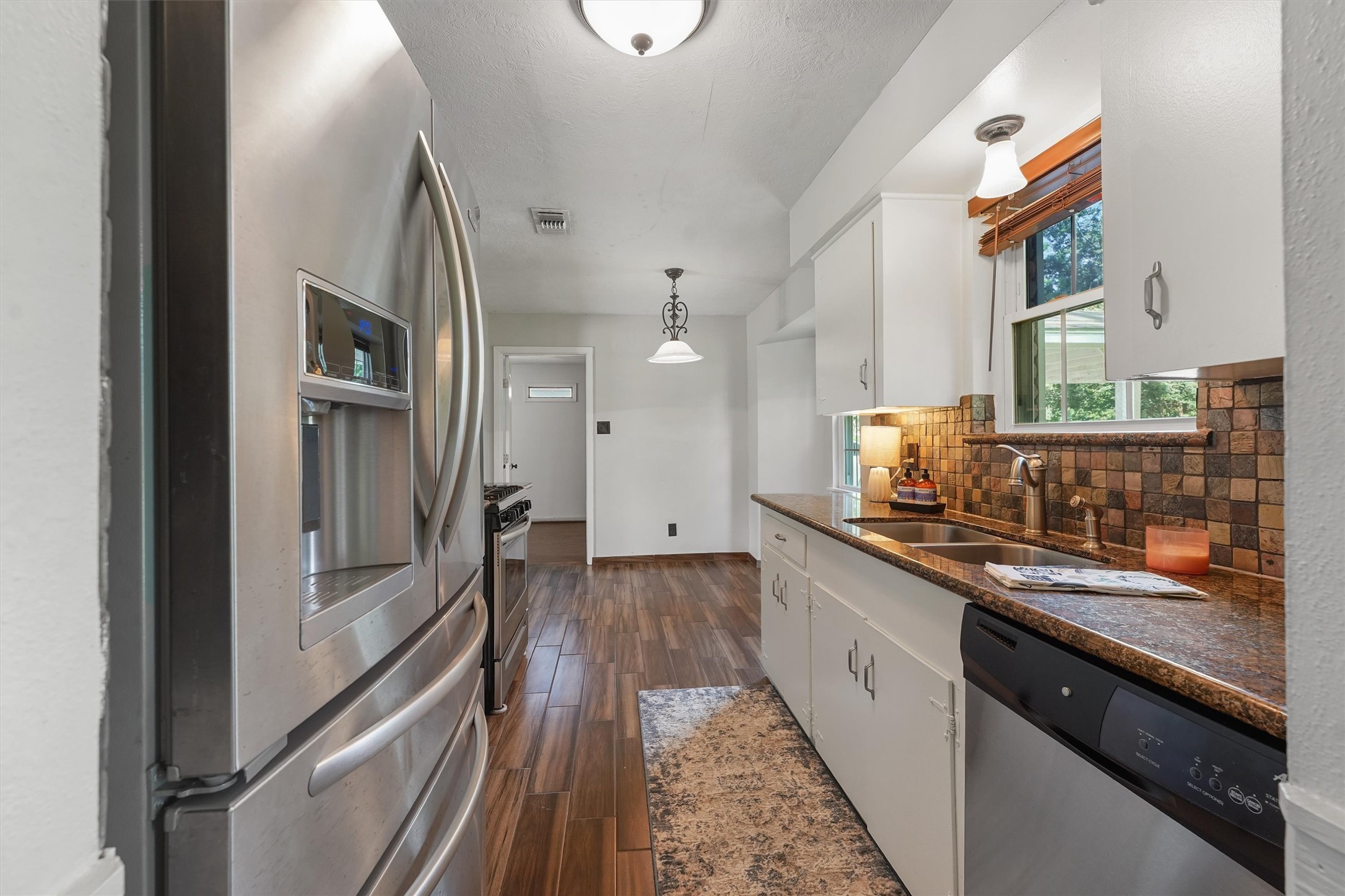 326 Broad Ripple Drive Houston, TX 77336 - Photo 11 of 26 a kitchen with stainless steel appliances granite countertop a refrigerator and a sink
