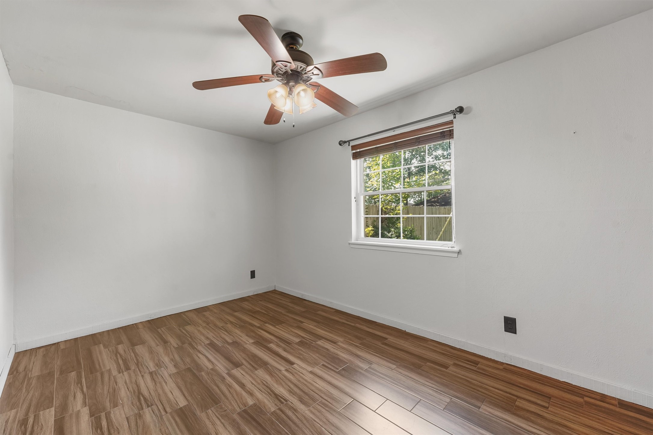 326 Broad Ripple Drive Houston, TX 77336 - Photo 15 of 26 wooden floor in an empty room with a window