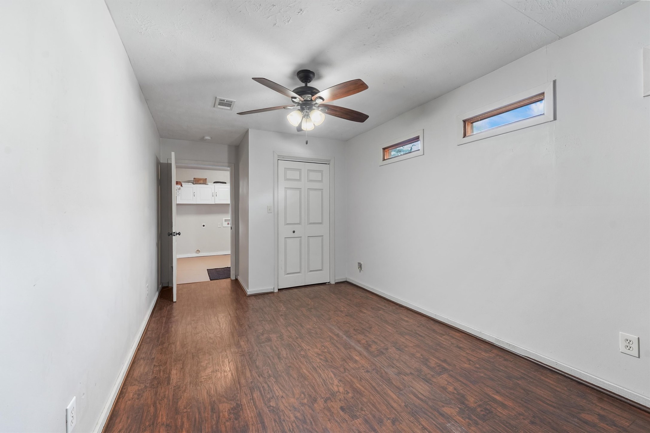 326 Broad Ripple Drive Houston, TX 77336 - Photo 18 of 26 an empty room with wooden floor closet and windows