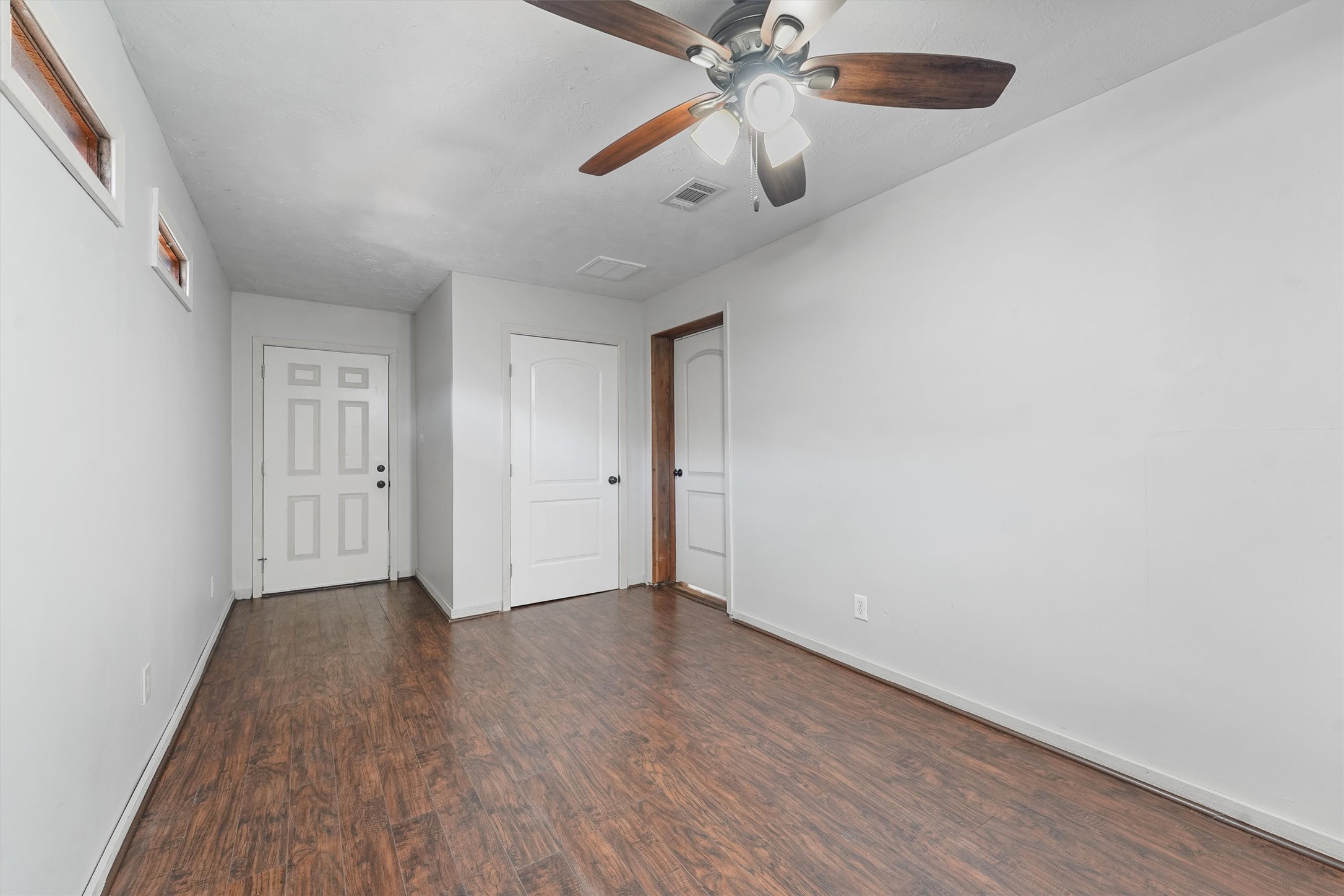 326 Broad Ripple Drive Houston, TX 77336 - Photo 19 of 26 an empty room with wooden floor closet and fan