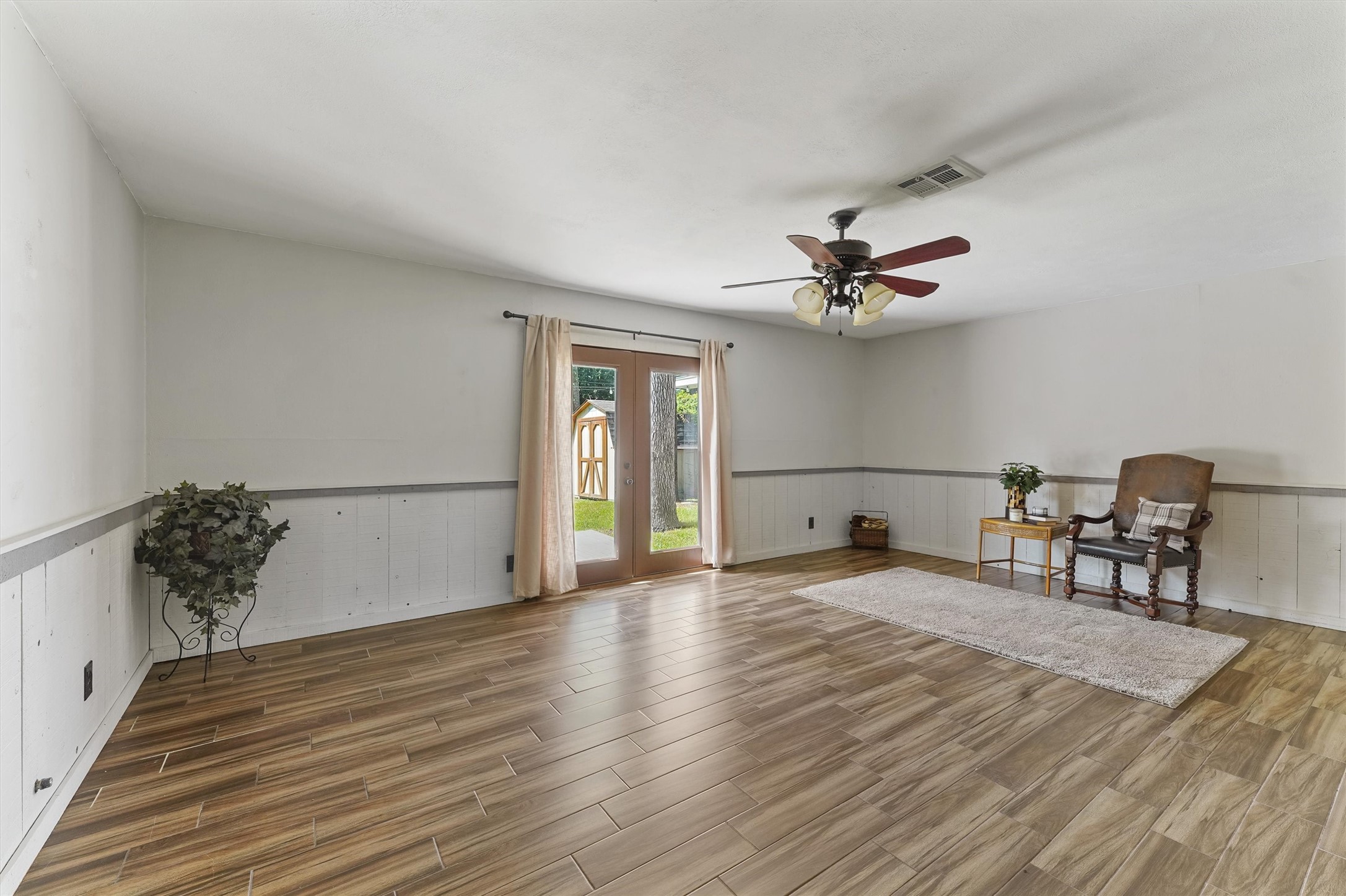 326 Broad Ripple Drive Houston, TX 77336 - Photo 4 of 26 a view of a livingroom with wooden floor and a ceiling fan
