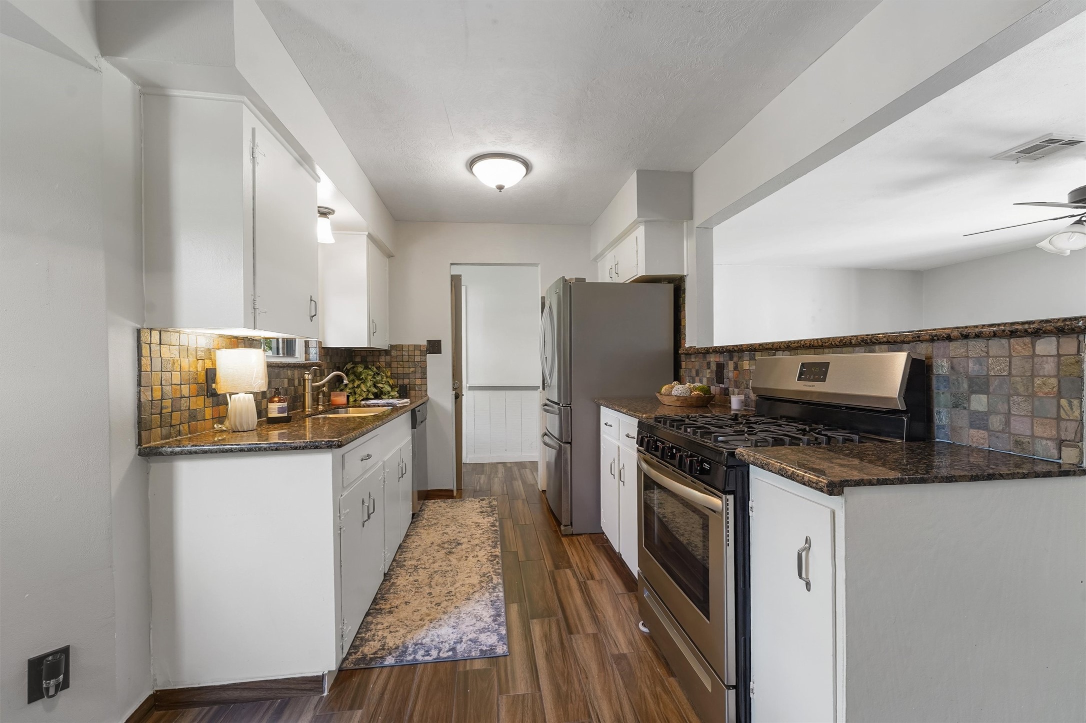 326 Broad Ripple Drive Houston, TX 77336 - Photo 10 of 26 a kitchen with granite countertop a refrigerator stove and sink