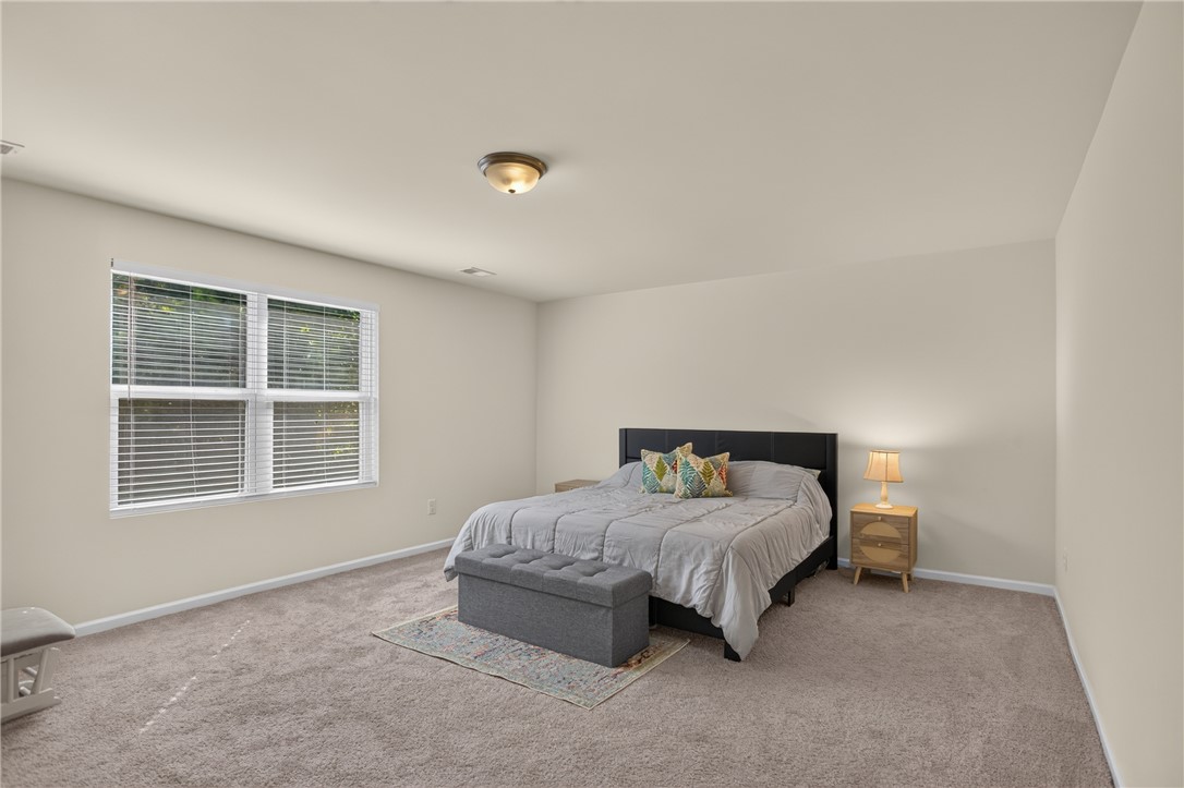1081 Edenbrooke Circle Anderson, SC 29621 - Photo 23 of 46 A well-lit bedroom provides a serene escape, featuring a broad window and plush carpet for comfort.