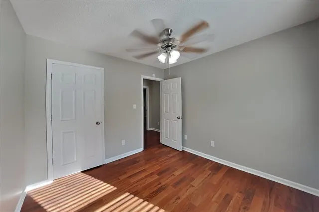 a view of an empty room with wooden floor