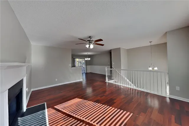 a view of livingroom with hardwood floor and a ceiling fan