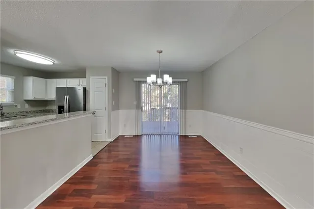 a view of a kitchen with an empty space and a window