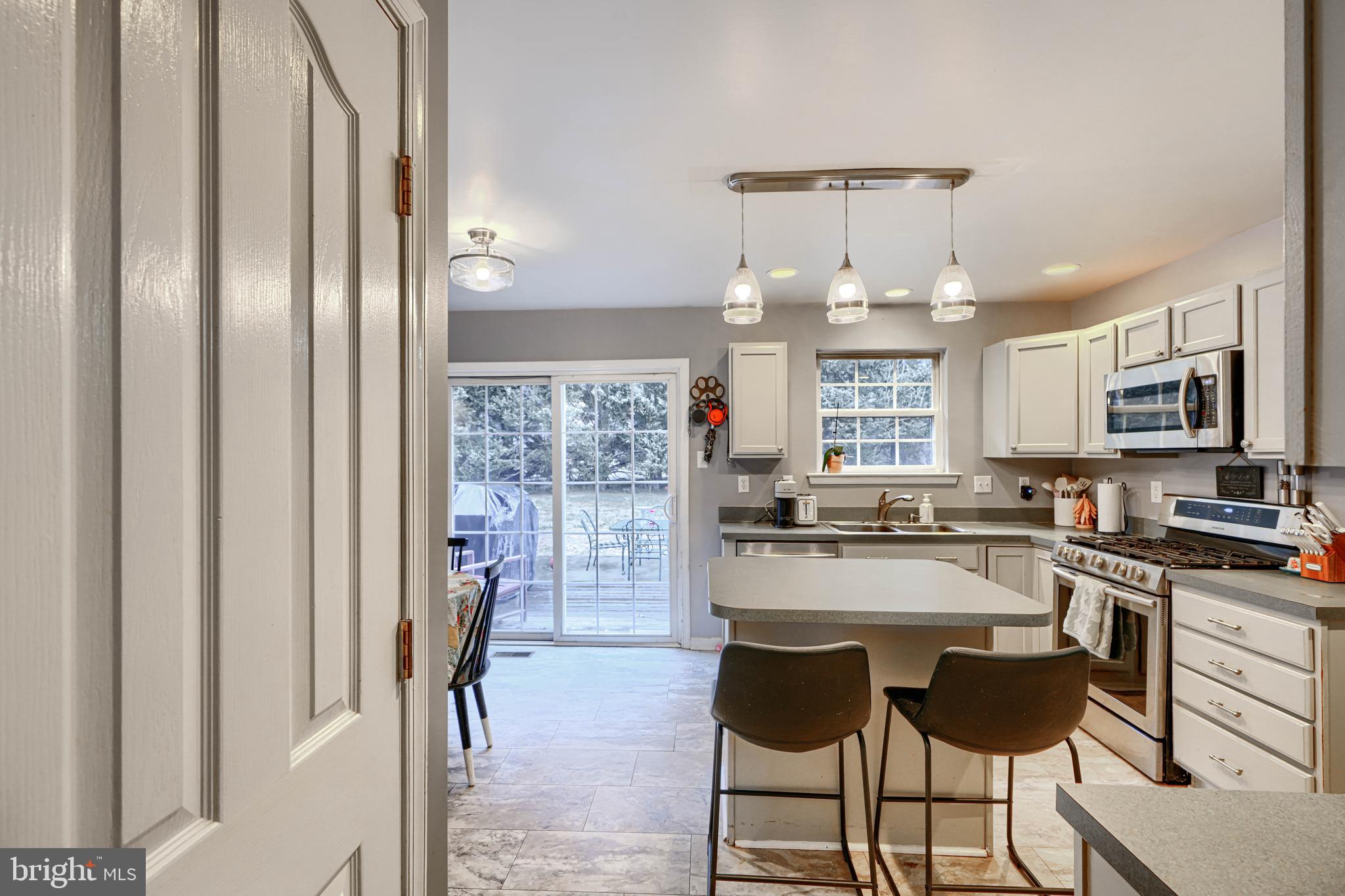 24 Ches Haven Road Earleville, MD 21919 - Photo 13 of 73 a kitchen with granite countertop a refrigerator a stove a dining table and chairs with wooden floor