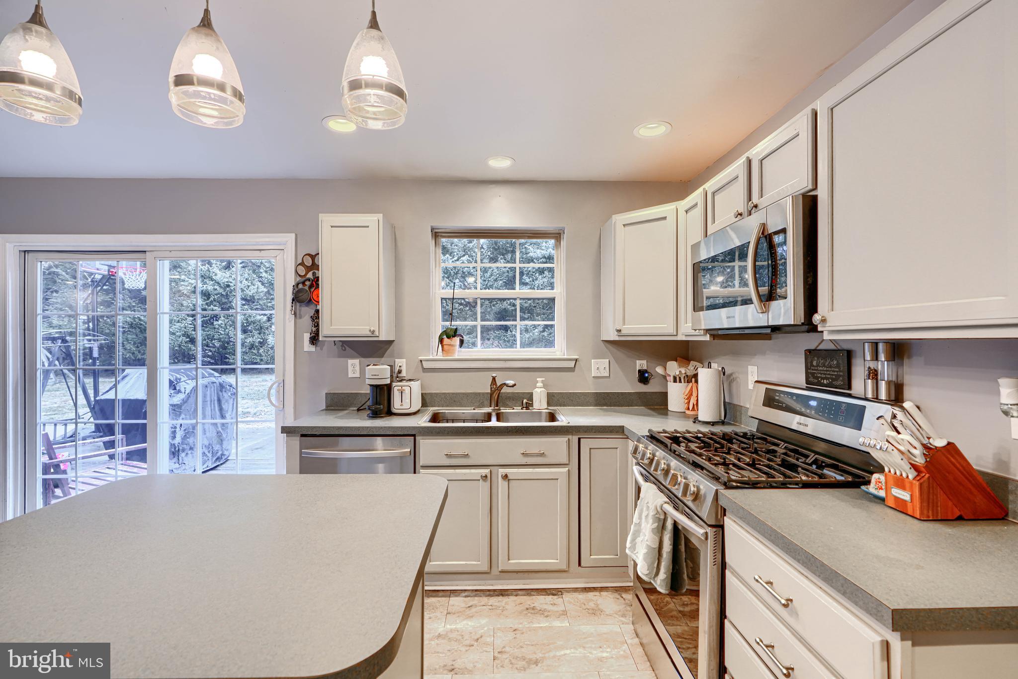 24 Ches Haven Road Earleville, MD 21919 - Photo 14 of 73 a kitchen with stainless steel appliances granite countertop a stove a sink dishwasher and a refrigerator with wooden cabinets