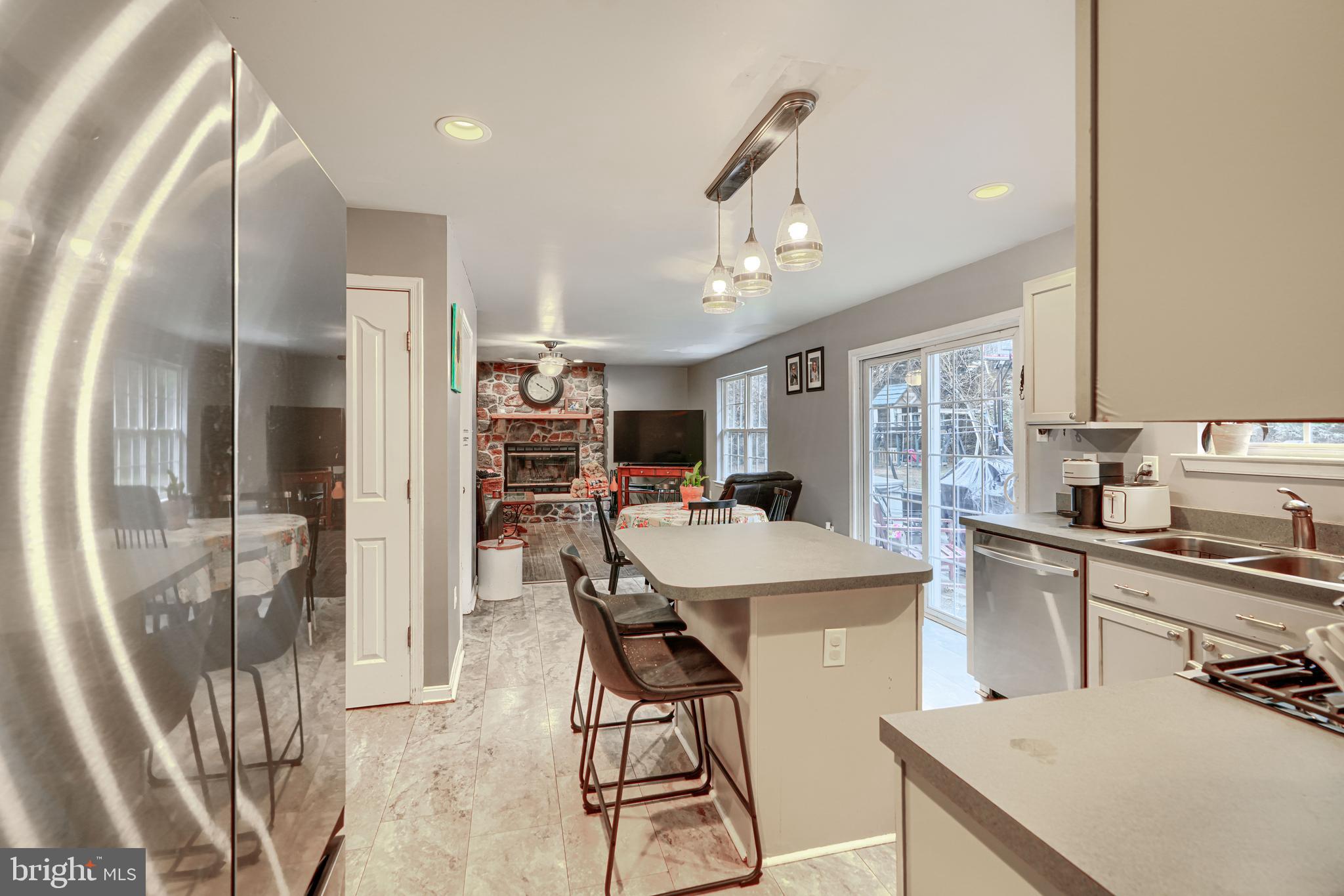 24 Ches Haven Road Earleville, MD 21919 - Photo 16 of 73 a kitchen with stainless steel appliances kitchen island granite countertop a refrigerator a stove a sink dishwasher and white cabinets with wooden floor