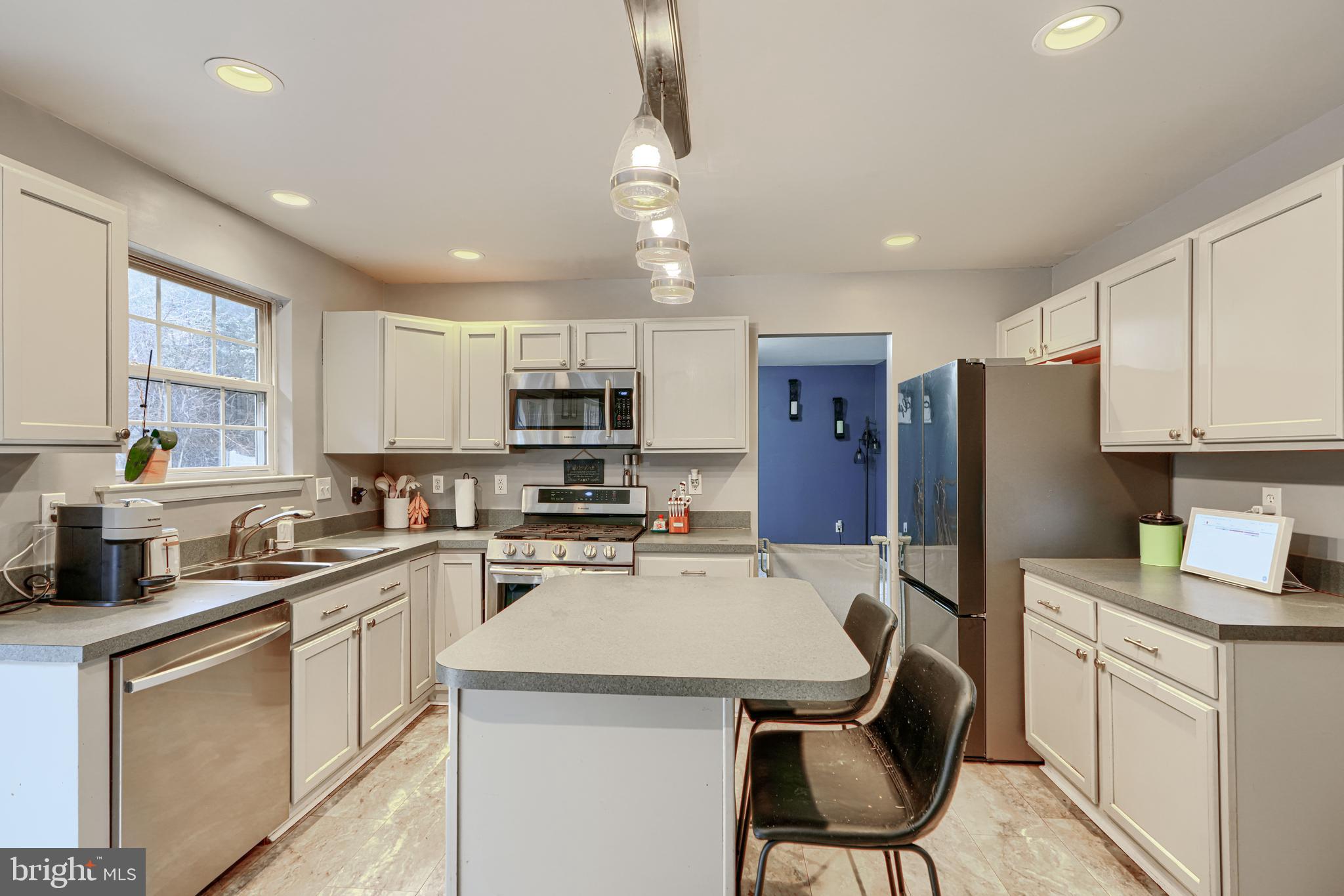 24 Ches Haven Road Earleville, MD 21919 - Photo 21 of 73 a kitchen with stainless steel appliances a stove refrigerator sink cabinets dining table and chairs
