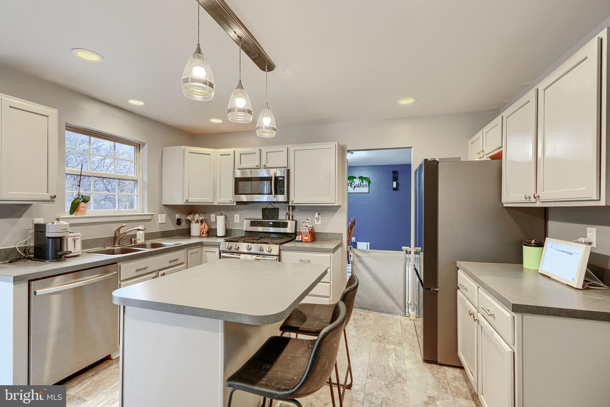 24 Ches Haven Road Earleville, MD 21919 - Photo 22 of 73 a kitchen that has a lot of cabinets in it wooden floor and appliances