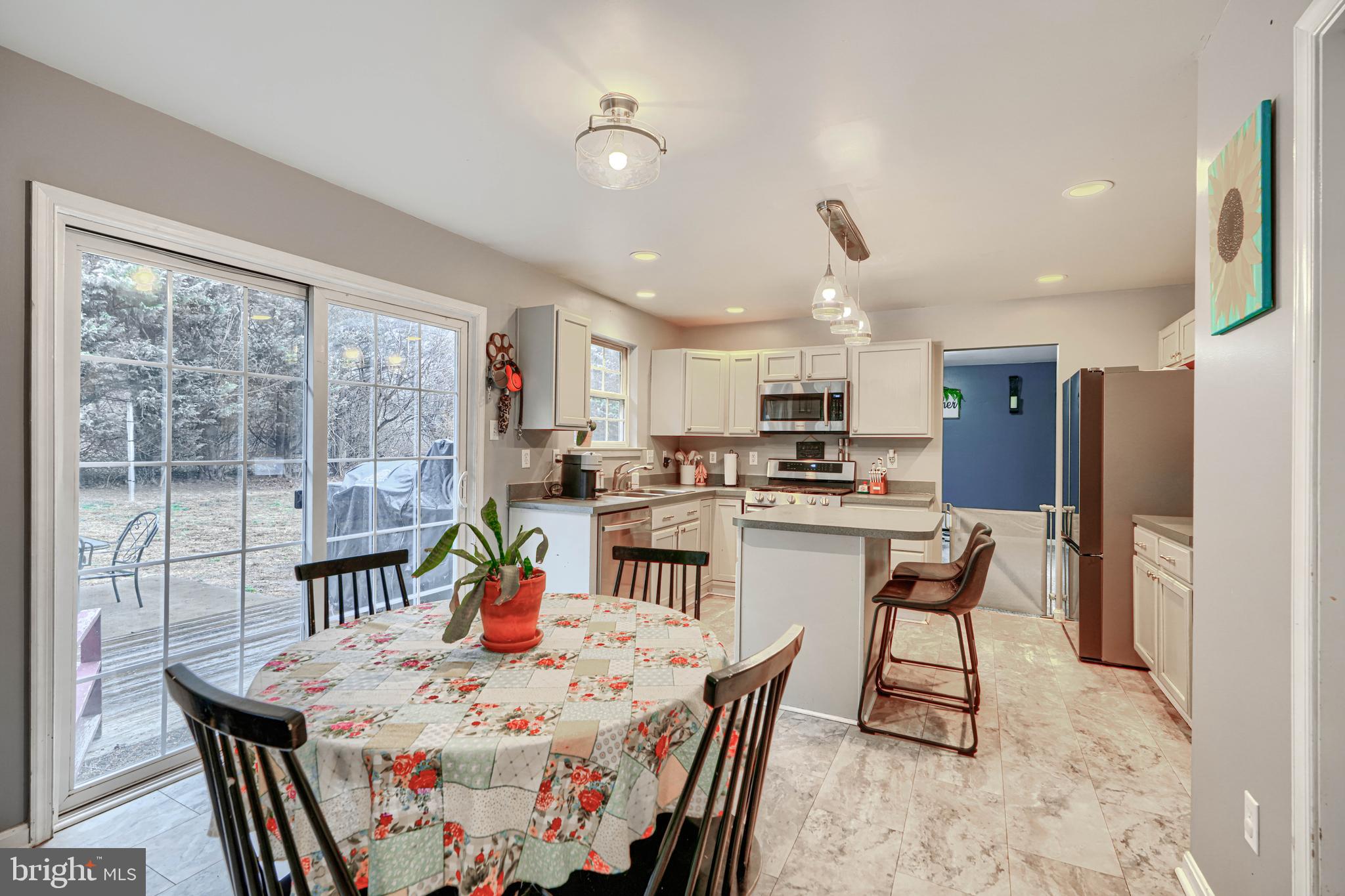 24 Ches Haven Road Earleville, MD 21919 - Photo 26 of 73 a kitchen with stainless steel appliances kitchen island granite countertop a dining table and chairs