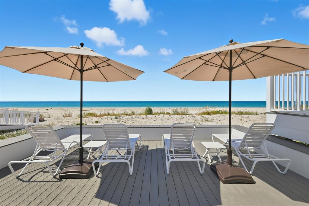 641 Boca Bay Drive Boca Grande, FL 33921 - Photo 53 of 74 a view of a terrace with furniture and umbrella