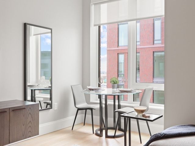 a view of a dining room with furniture and window