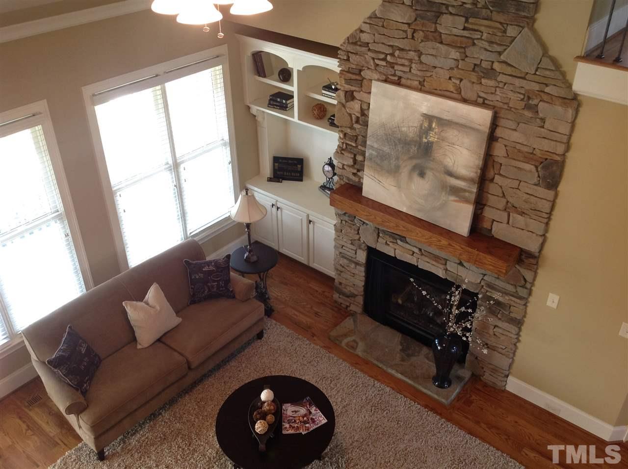 305 Woodlief Farm Road Rolesville, NC 27571 - Photo 3 of 25 Stunning Great Room is enhanced with hardwood floors and gas log stone fireplace.