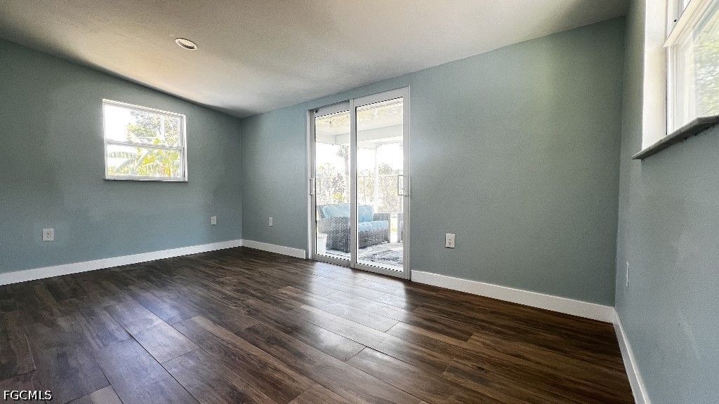 144 Whidden Road North Fort Myers, FL 33917 - Photo 13 of 16 an empty room with wooden floor and windows