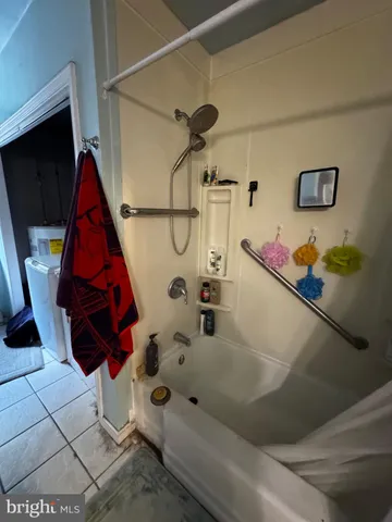 a bathroom with a bathtub and shower