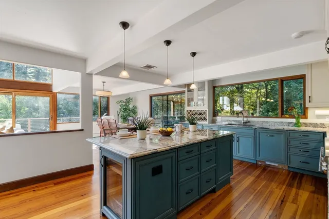 a kitchen with a sink stove and wooden cabinets
