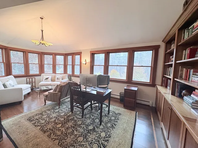 a workspace with furniture wooden floor and a book shelf