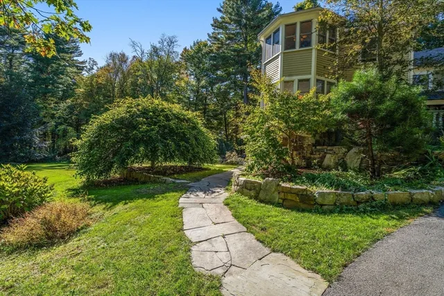 a front view of a house with garden