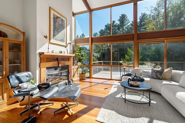 a living room with patio furniture and a floor to ceiling window