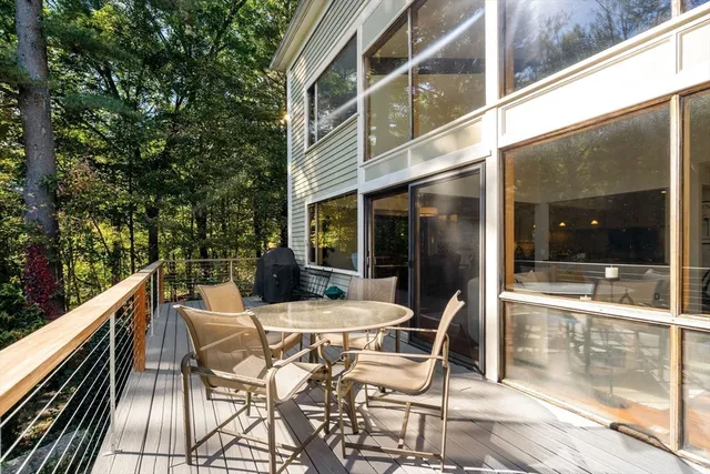 a view of a patio with table and chairs and floor to ceiling window