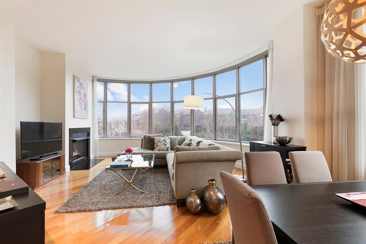 8100 River Road, Unit 218 North Bergen, NJ 07047 - Photo 1 of 1 a living room with furniture tv and a large window
