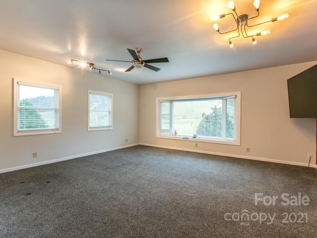 20 Brooks Branch Road Leicester, NC 28748 - Photo 12 of 40 a view of a livingroom with a ceiling fan and window