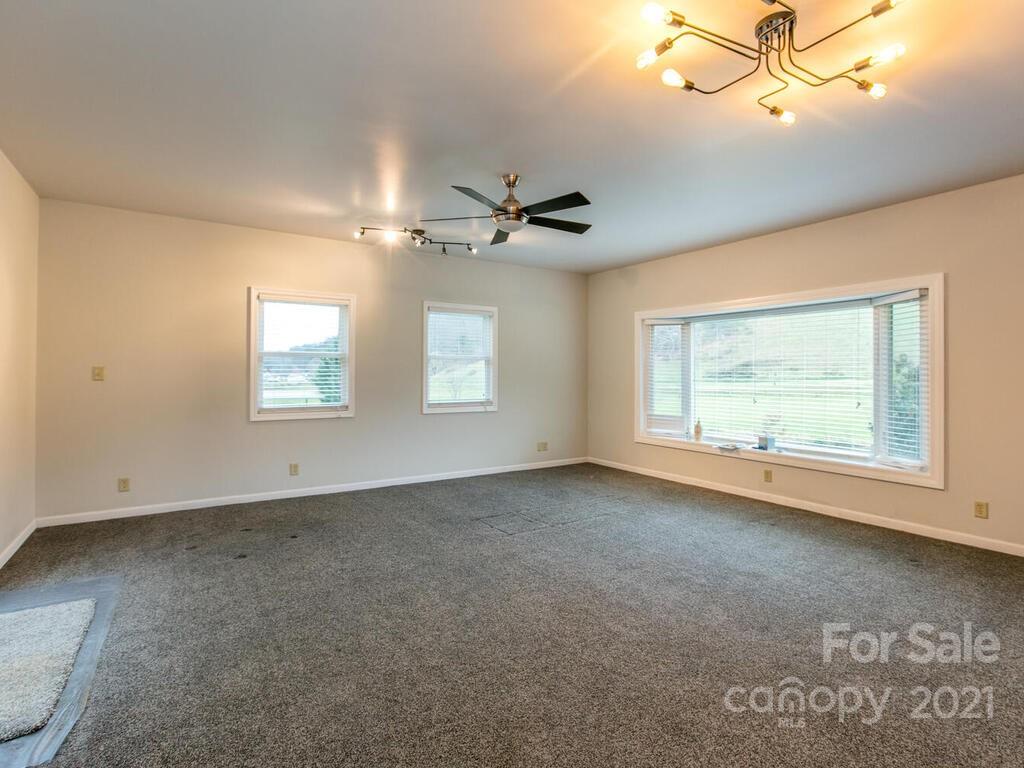 20 Brooks Branch Road Leicester, NC 28748 - Photo 13 of 40 an empty room with windows and fan