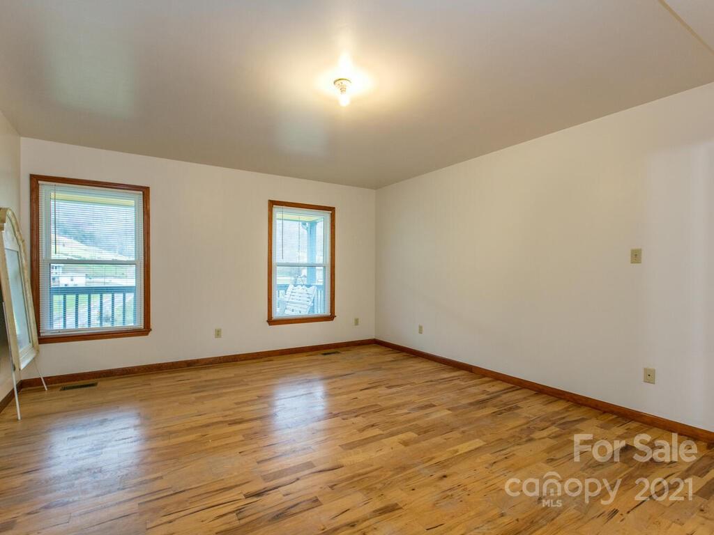 20 Brooks Branch Road Leicester, NC 28748 - Photo 21 of 40 an empty room with wooden floor and windows