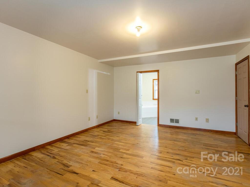 20 Brooks Branch Road Leicester, NC 28748 - Photo 22 of 40 an empty room with wooden floor and windows