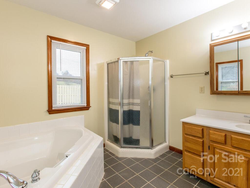 20 Brooks Branch Road Leicester, NC 28748 - Photo 23 of 40 a bathroom with a tub shower and sink